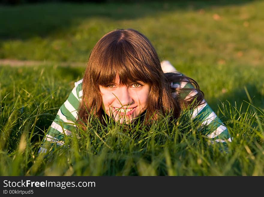 Pretty girl is stolen on a dense green grass. Pretty girl is stolen on a dense green grass