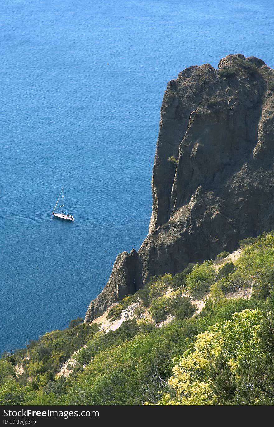 Sea,  rocks and yacht