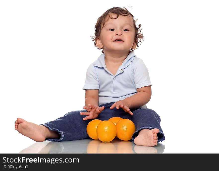 The child playing with oranges. The child playing with oranges.