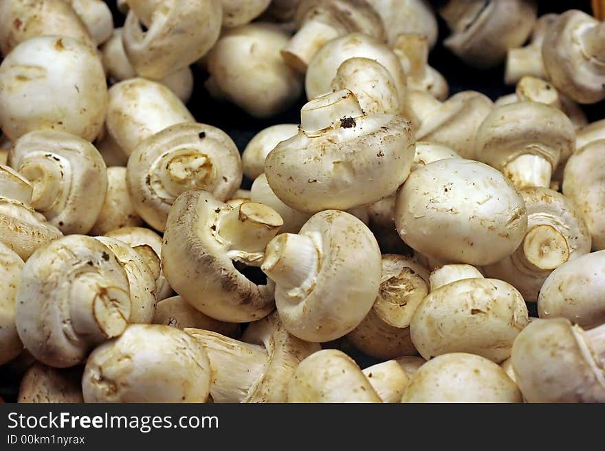 White button mushrooms for sale in a vegetable market