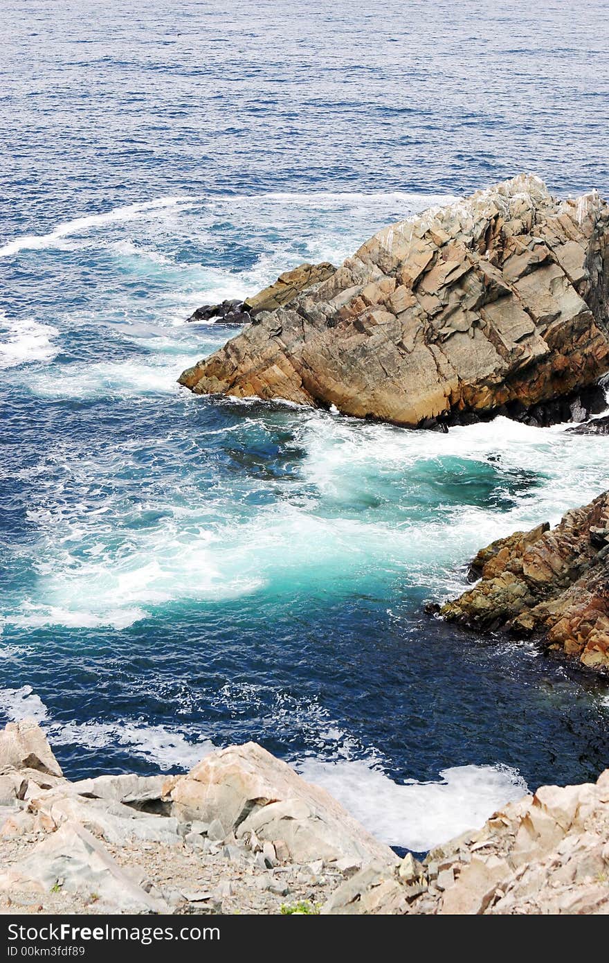 Aerial view of the waves, rocks and ocean.