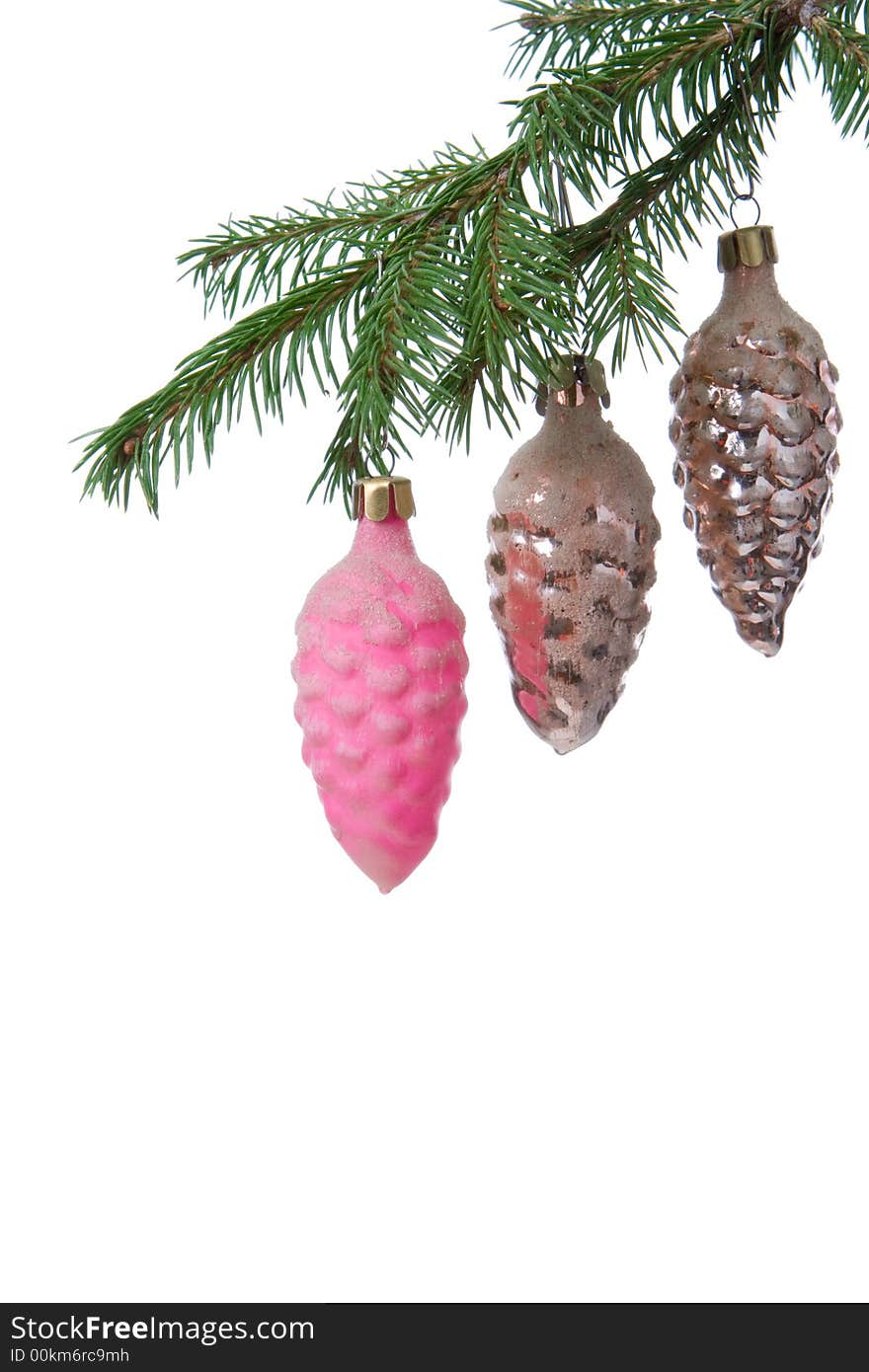 Christmas tree decoration cone and fir branch over white background