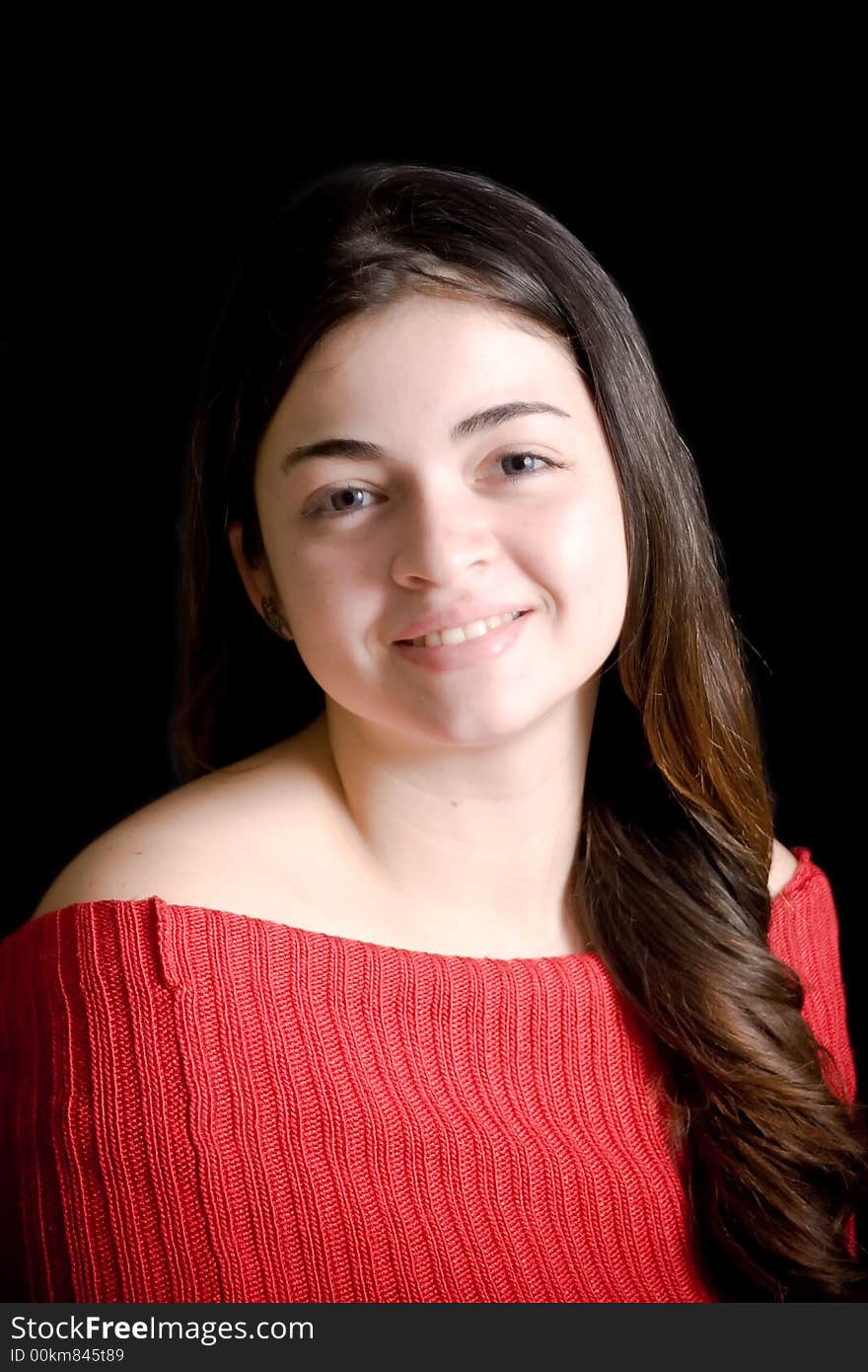 Portrait of beautiful hispanic woman with long hair, over black