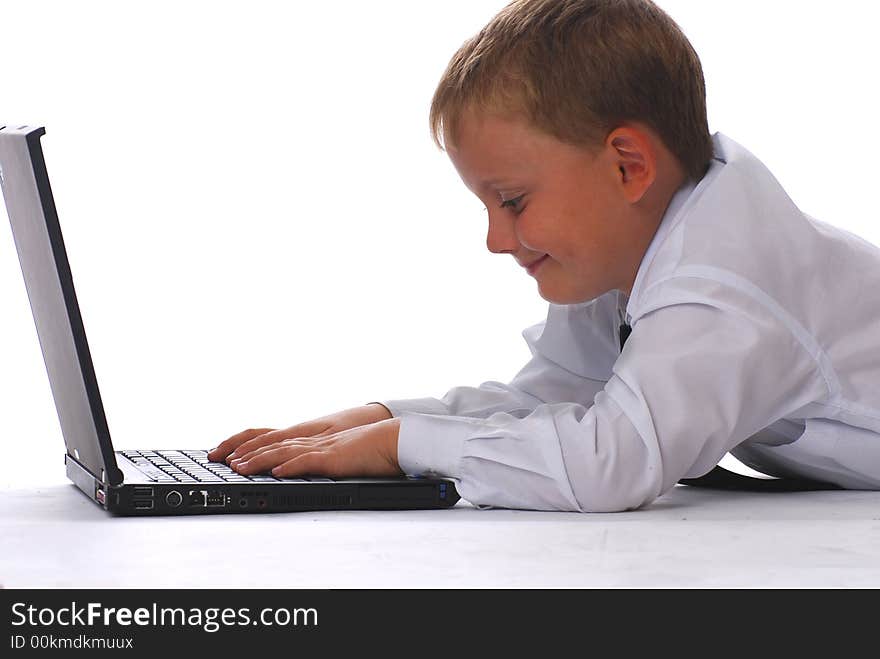 A boy with laptop isolated on white