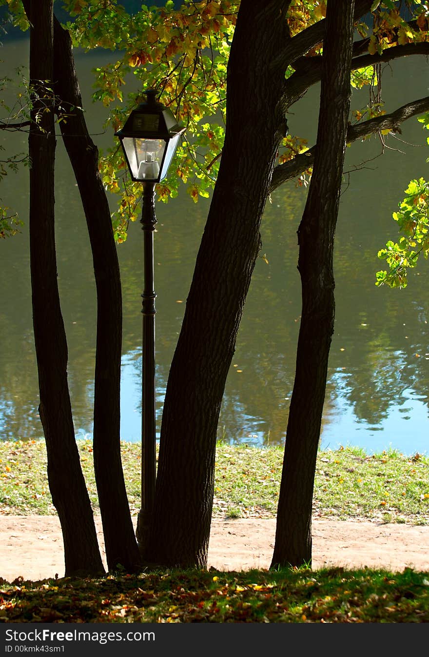 Alone street-lamp in autumn park