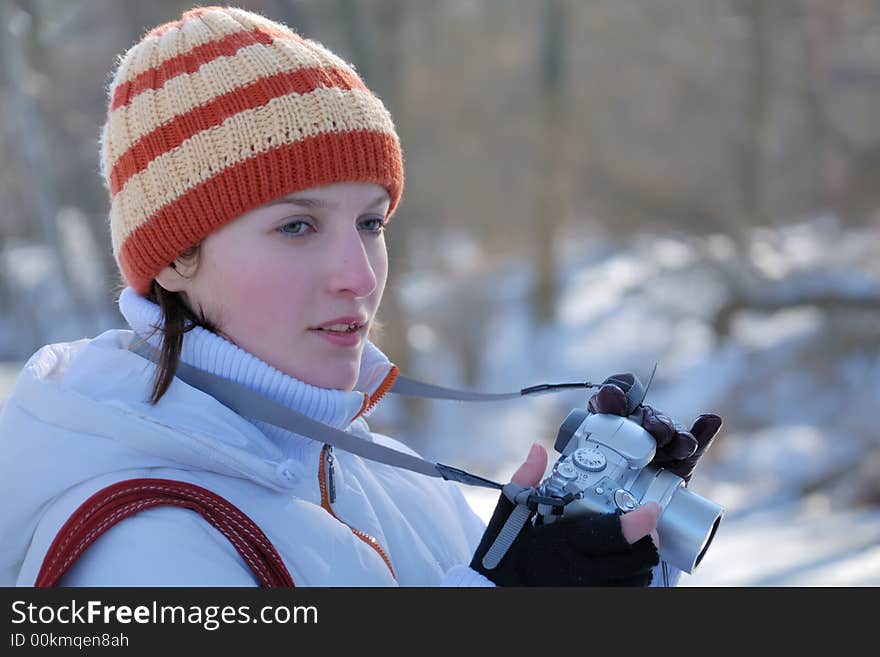 Young photographer on winter background