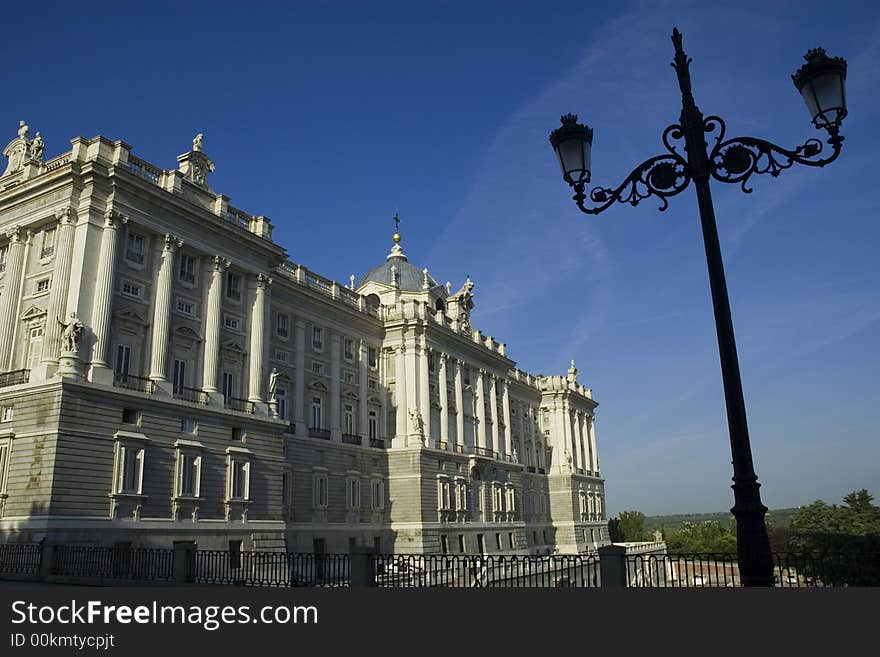 The Royal Palace in the morning light framed with a typical lamppost, in Madrid, Spain. The Royal Palace in the morning light framed with a typical lamppost, in Madrid, Spain.