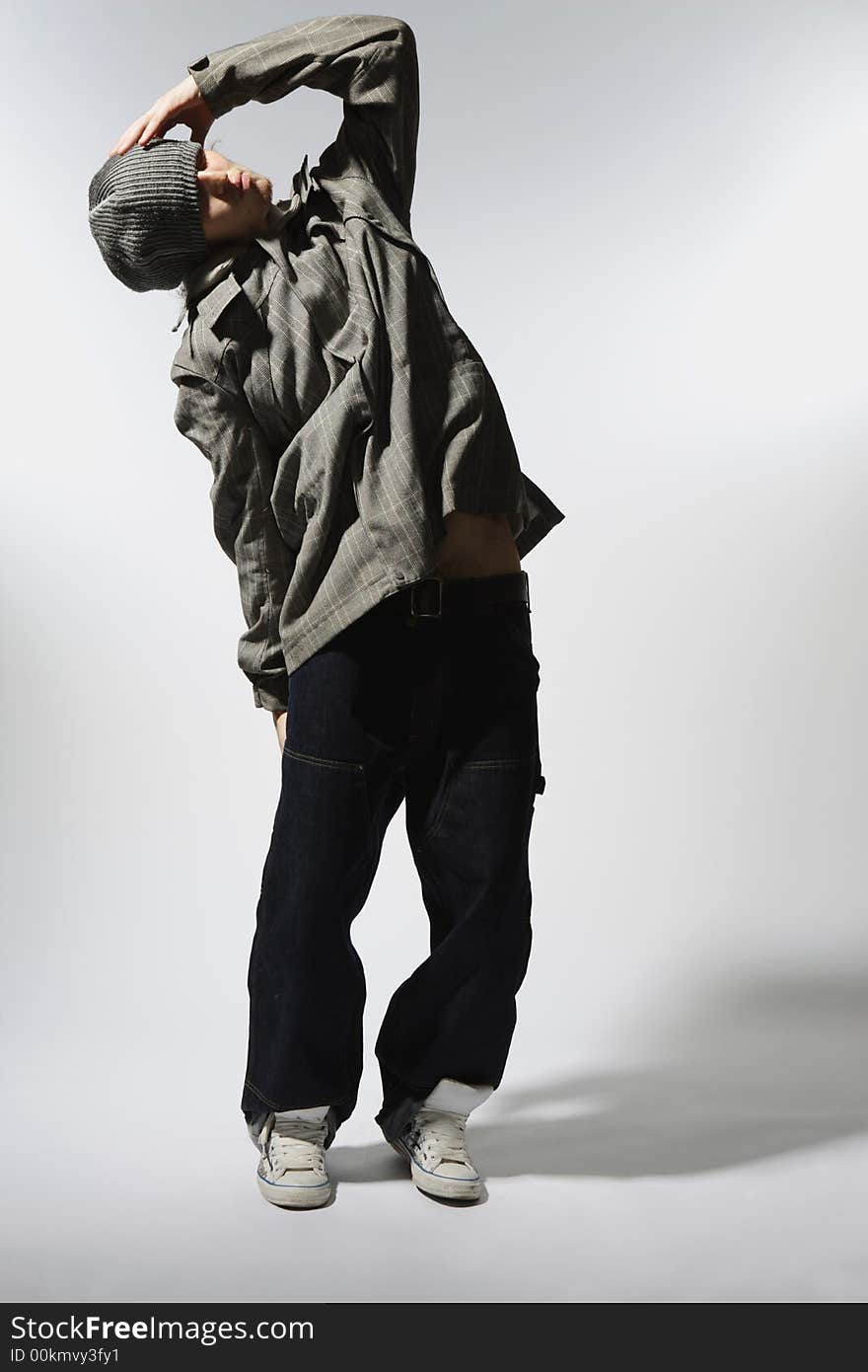 Coll looking dancer posing on a grunge grey wall. Coll looking dancer posing on a grunge grey wall