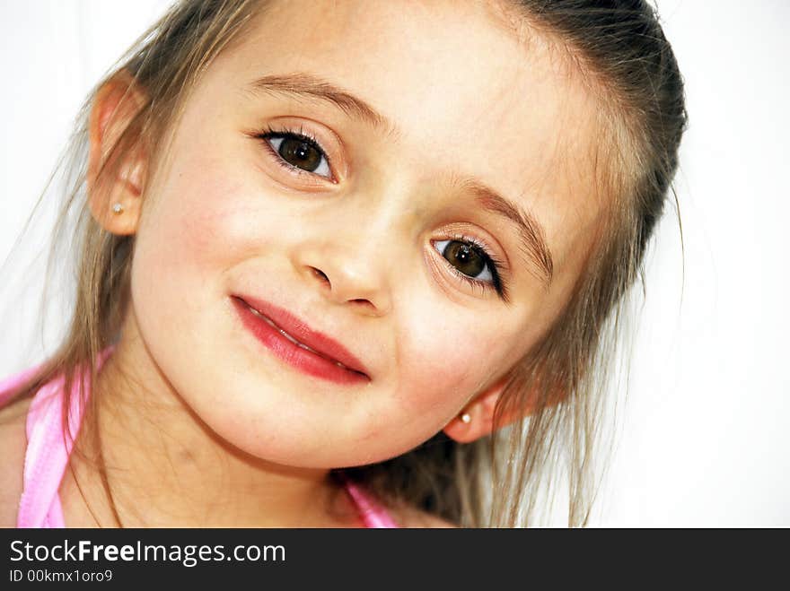 Beautiful young toddler child with brown hair and brown eyes and her hair a bit messed-up. Beautiful young toddler child with brown hair and brown eyes and her hair a bit messed-up.