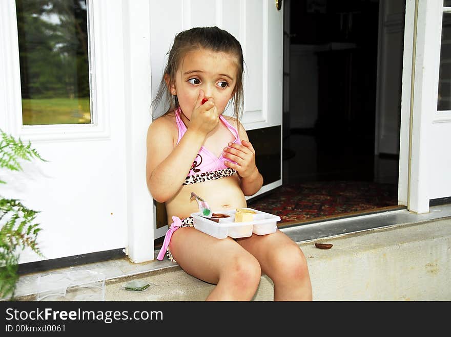 Cute little girl taking time out for a snack. Cute little girl taking time out for a snack.