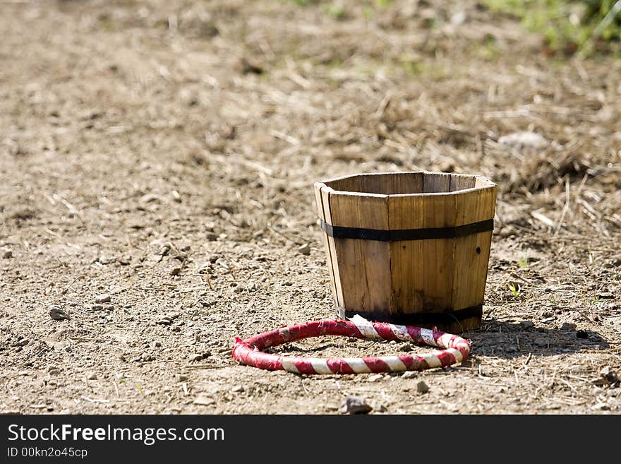 A competition ring lays next to a bucket. A competition ring lays next to a bucket