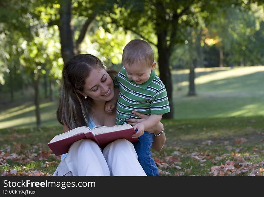 Mother reading a book to her son. Mother reading a book to her son