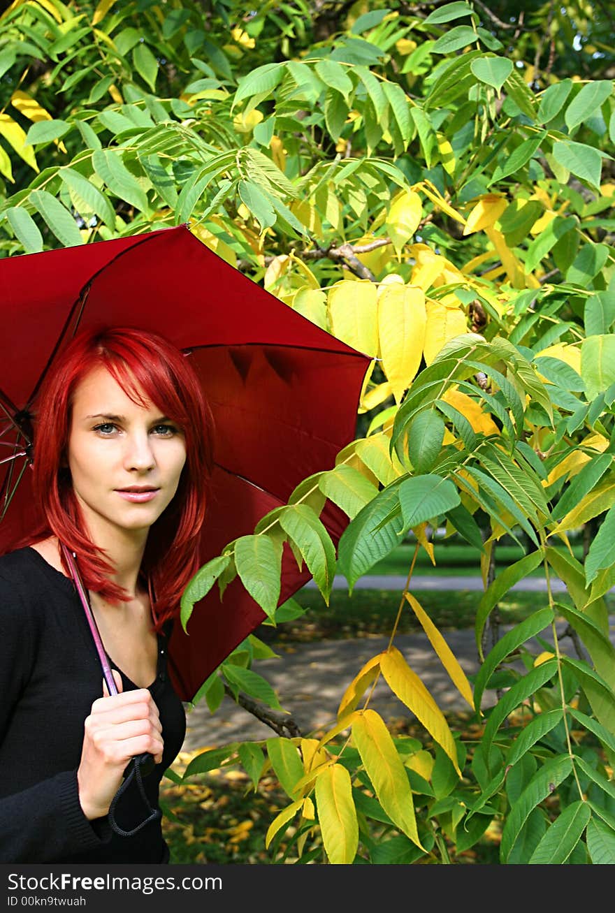 Beautiful girl under red umbrella. Beautiful girl under red umbrella