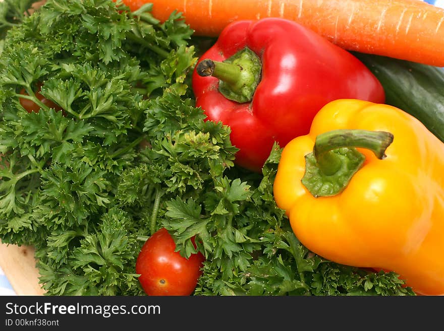 Parsley, cherry tomatoes, capsicums, carrot and cucumber on wooden board. Parsley, cherry tomatoes, capsicums, carrot and cucumber on wooden board