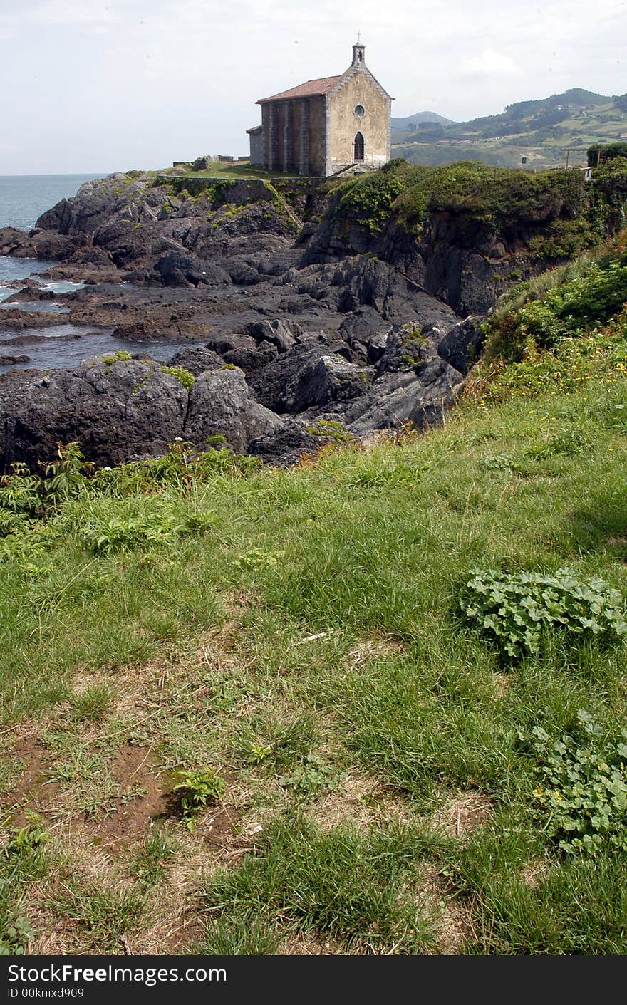 A smal church standing on a sea shore. A smal church standing on a sea shore