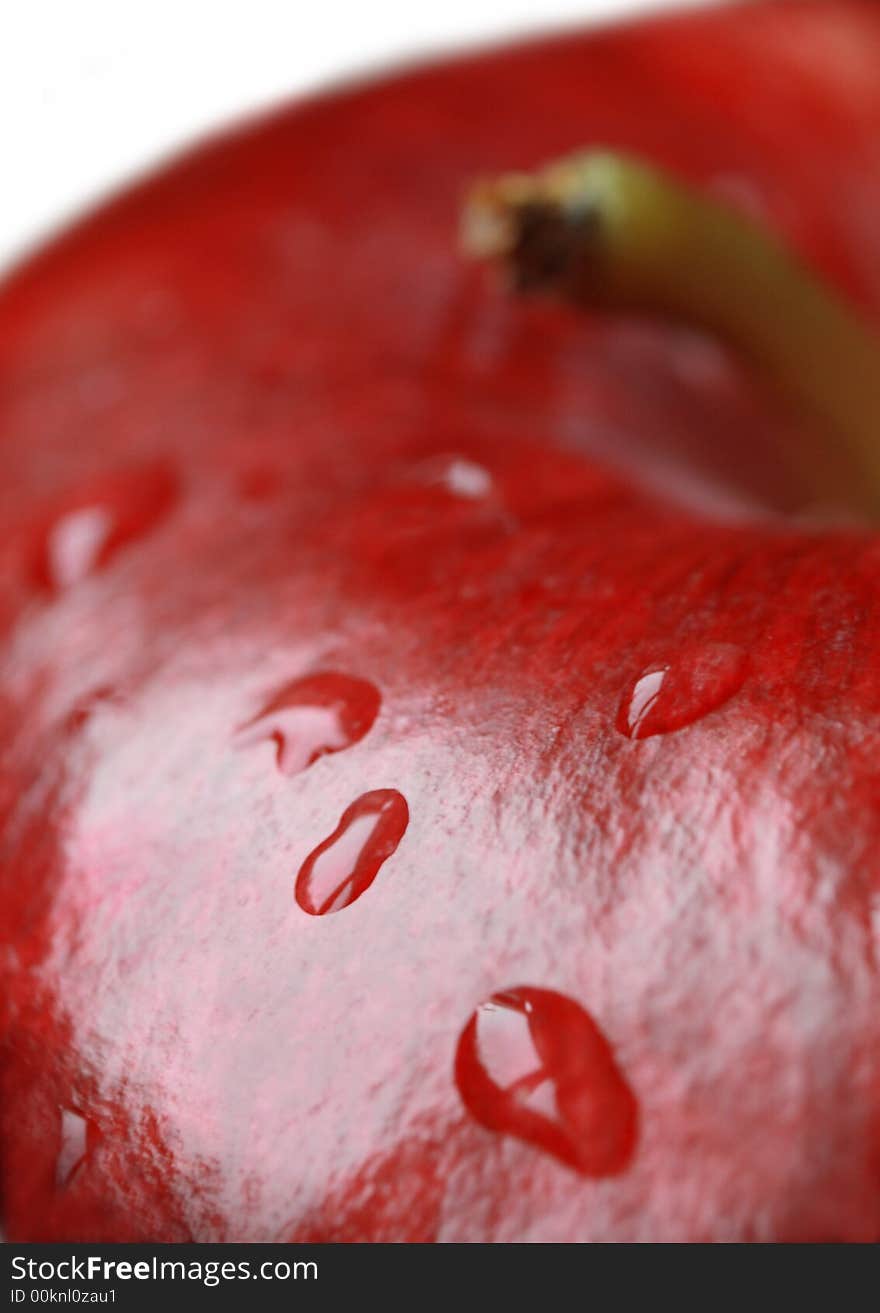 Red apple covered with water droplets . Red apple covered with water droplets .