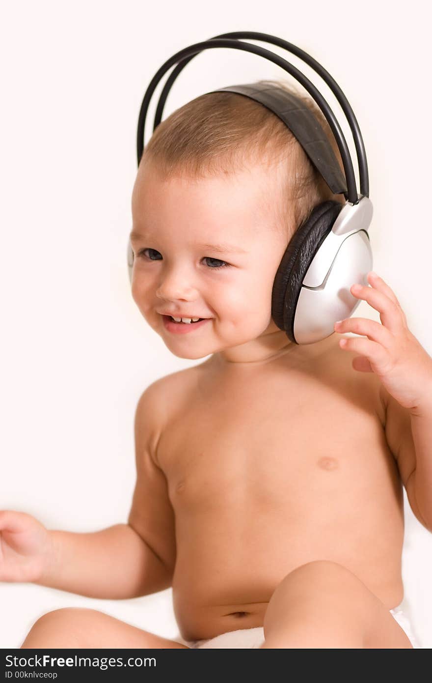 Little child listen to headphones. Little child listen to headphones