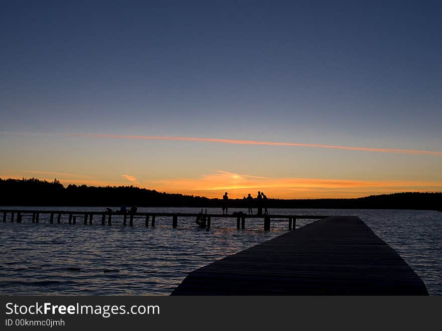 Sunset over treeline at the lake