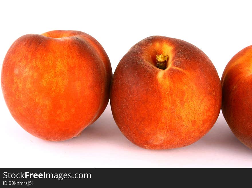 Ripe Peach with Leaf on White Background