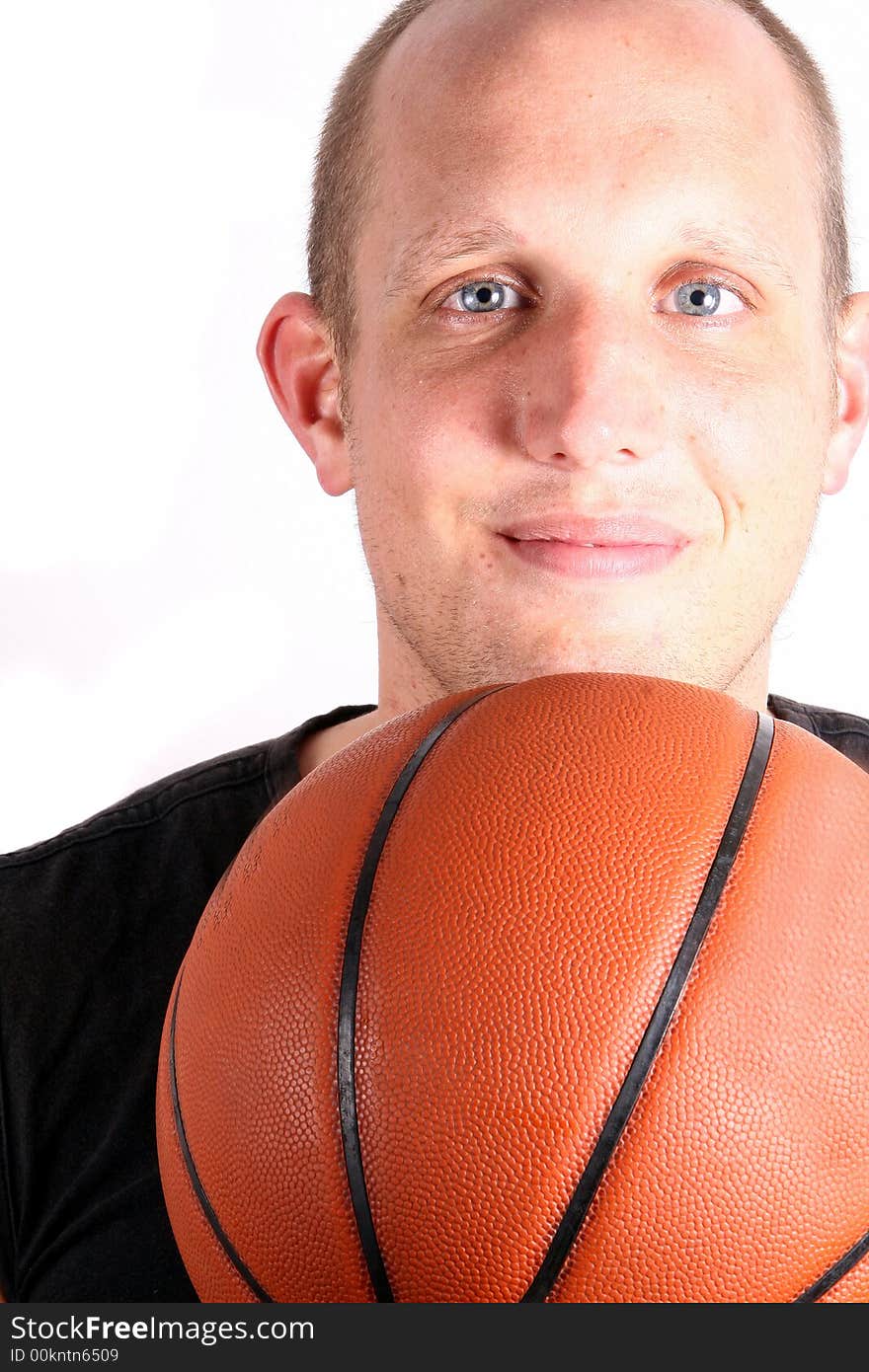 Close up of a young man with bright blue eyes and a basketball! Isolated over white!. Close up of a young man with bright blue eyes and a basketball! Isolated over white!