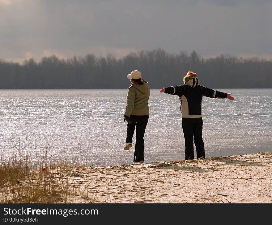 Happy woman with arms wide open at the coast. Happy woman with arms wide open at the coast