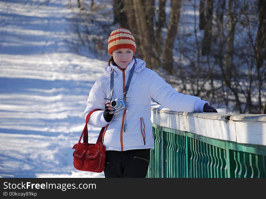 Young photographer on winter background