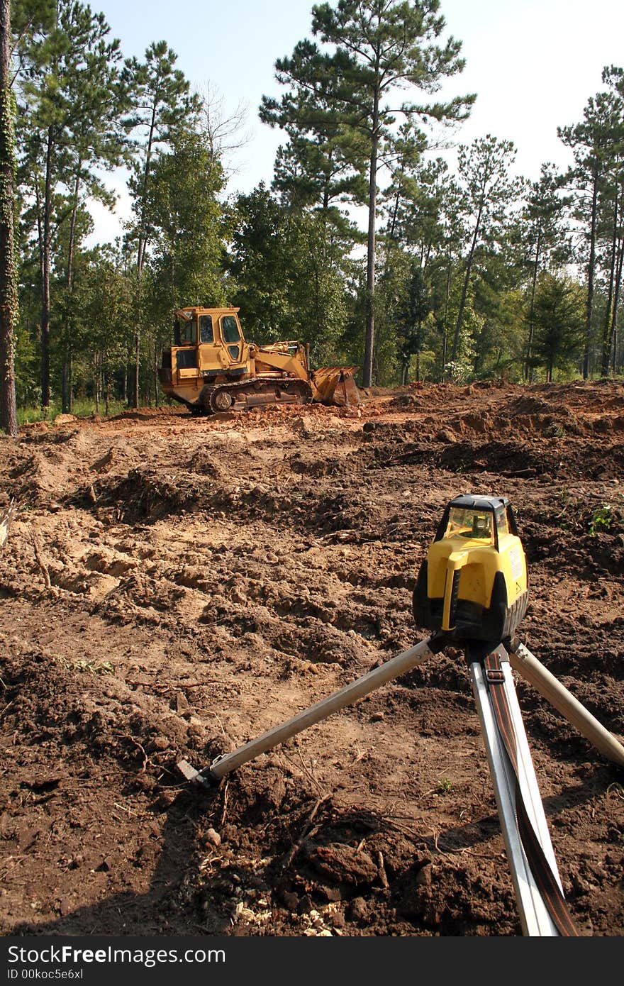 Construction setting transit level on home construction site. Construction setting transit level on home construction site