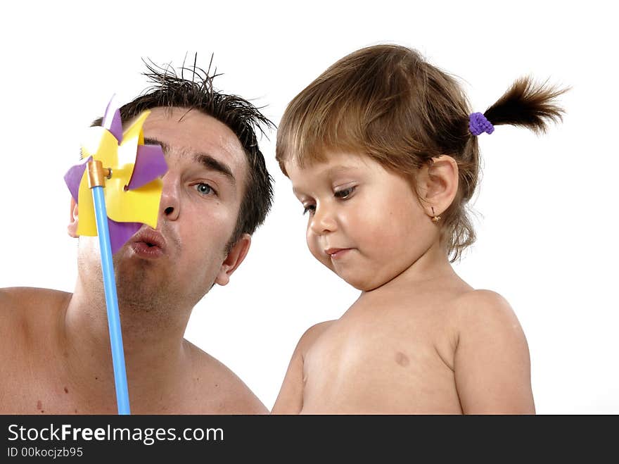 Picture of happy family - father with daughter play with pinwheel