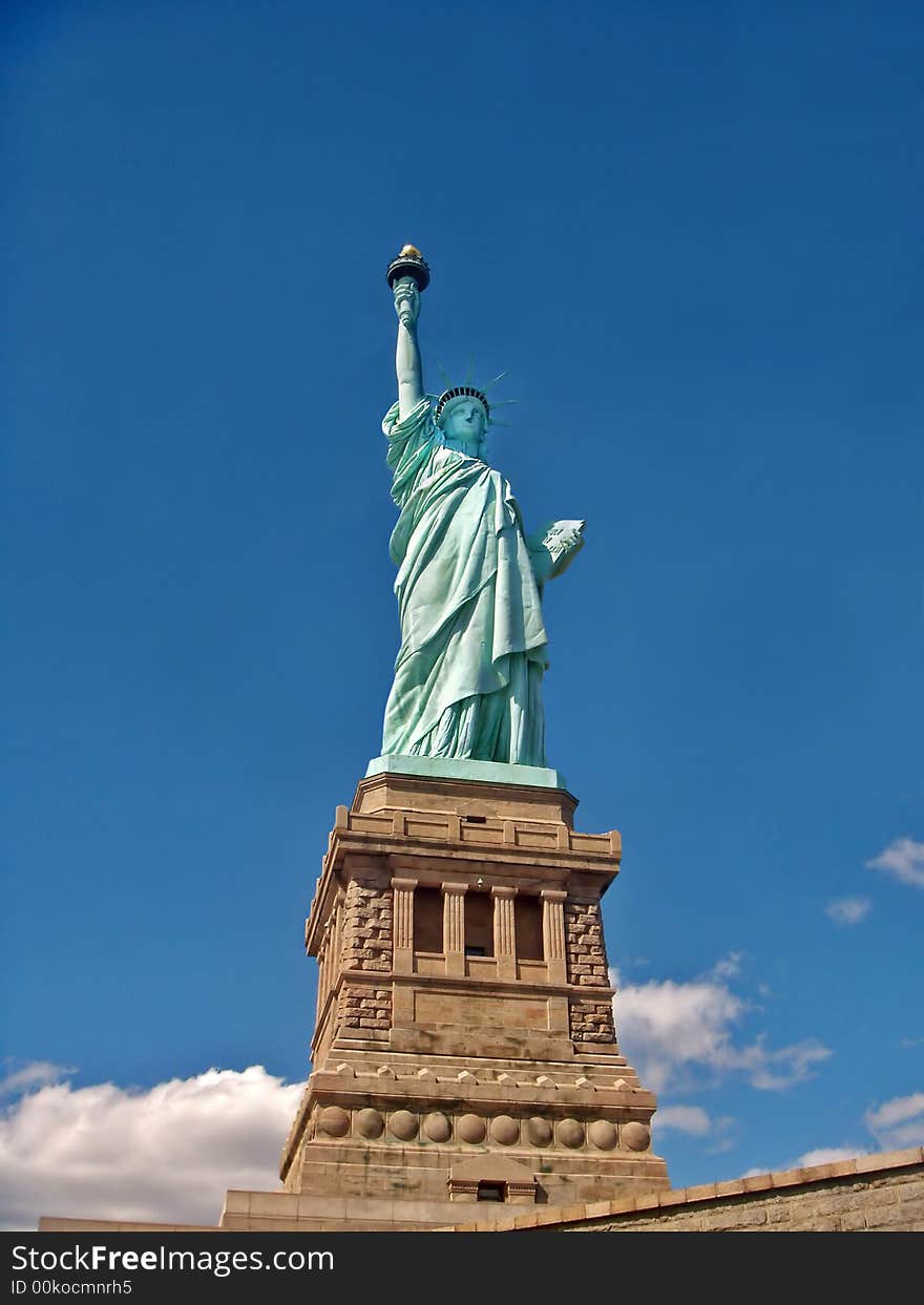 Portrait shot of the Statue of Liberty on a beautiful blue skies.
