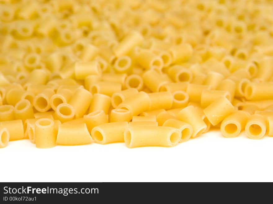 Close up of uncooked macaroni isolated on a white background