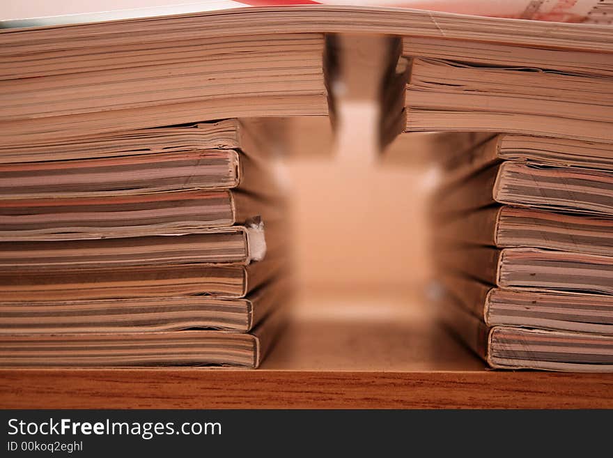 Many books arranged on a wooden shelf