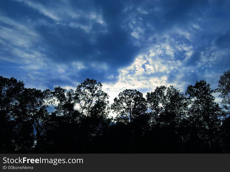 A beautiful photo of a set of clouds taken out behind my house, with a deep blue sky and the suns's rays escaping behind the clouds. A beautiful photo of a set of clouds taken out behind my house, with a deep blue sky and the suns's rays escaping behind the clouds.