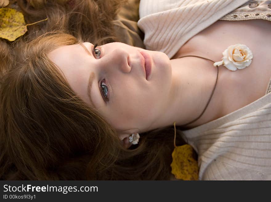 Beautiful lying girl autumn portrait. Beautiful lying girl autumn portrait