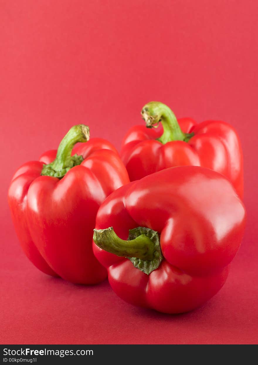 Still of red large beefy red peppers on red background. Still of red large beefy red peppers on red background