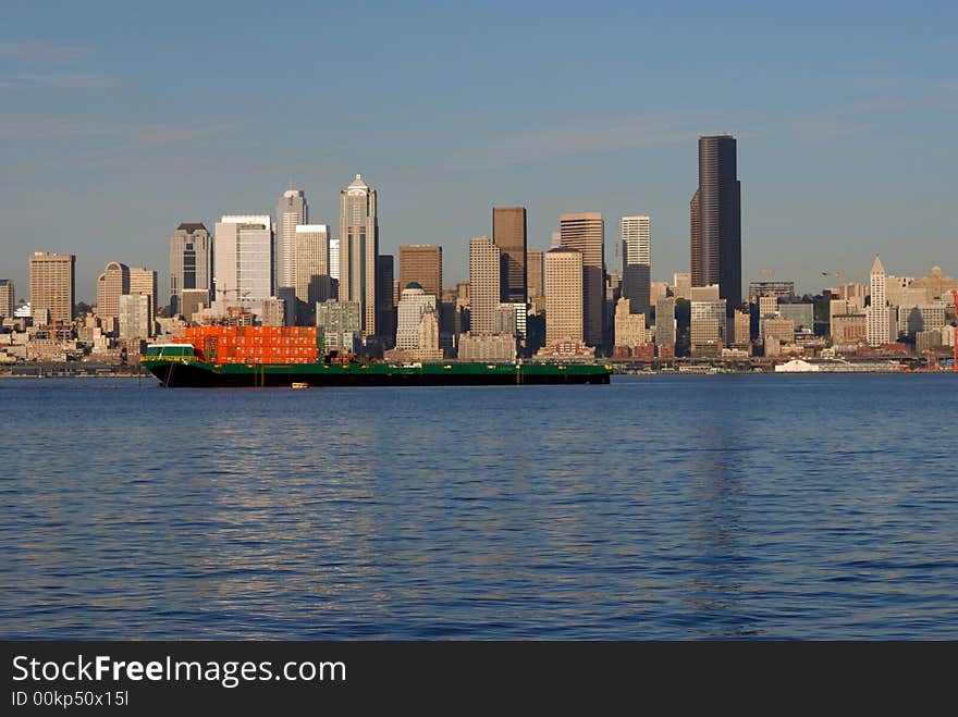 A ship is passing by the downtown Seattle Skyline. A ship is passing by the downtown Seattle Skyline