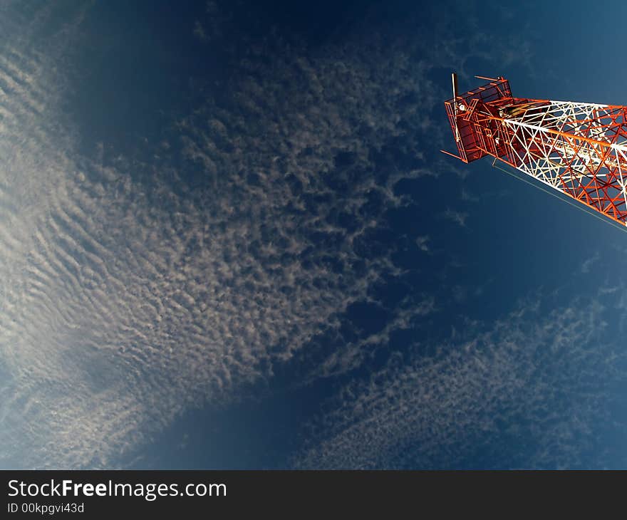 A coastal surveillance tower catching the warm golden light of the early morning sun in a Altocumulus mackerel sky. A coastal surveillance tower catching the warm golden light of the early morning sun in a Altocumulus mackerel sky.