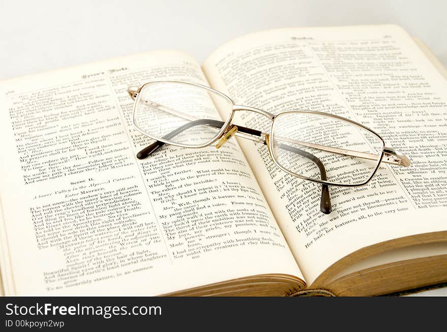 Glasses laying on the old book