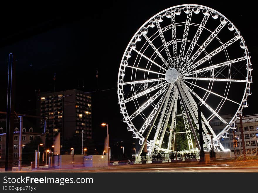 A ferry wheel in a city. A ferry wheel in a city.