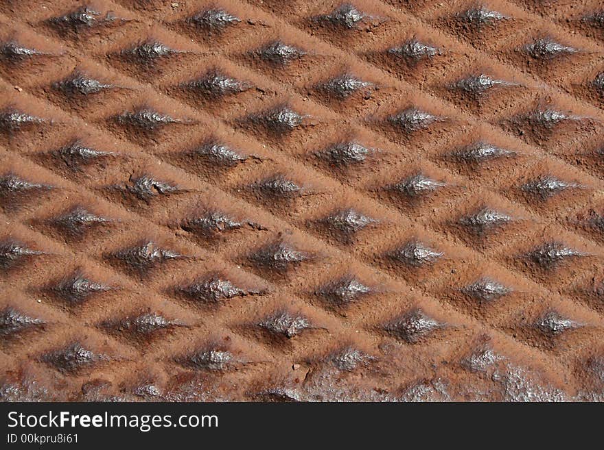 Close up of a diamond shaped metal rusty background. Close up of a diamond shaped metal rusty background