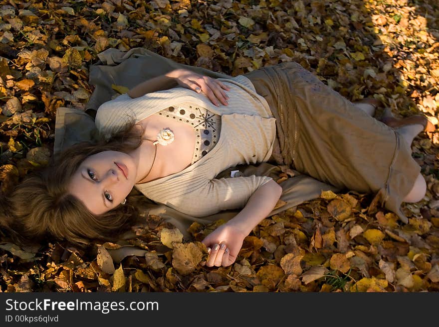 Girl lying on autumn leaves. Girl lying on autumn leaves