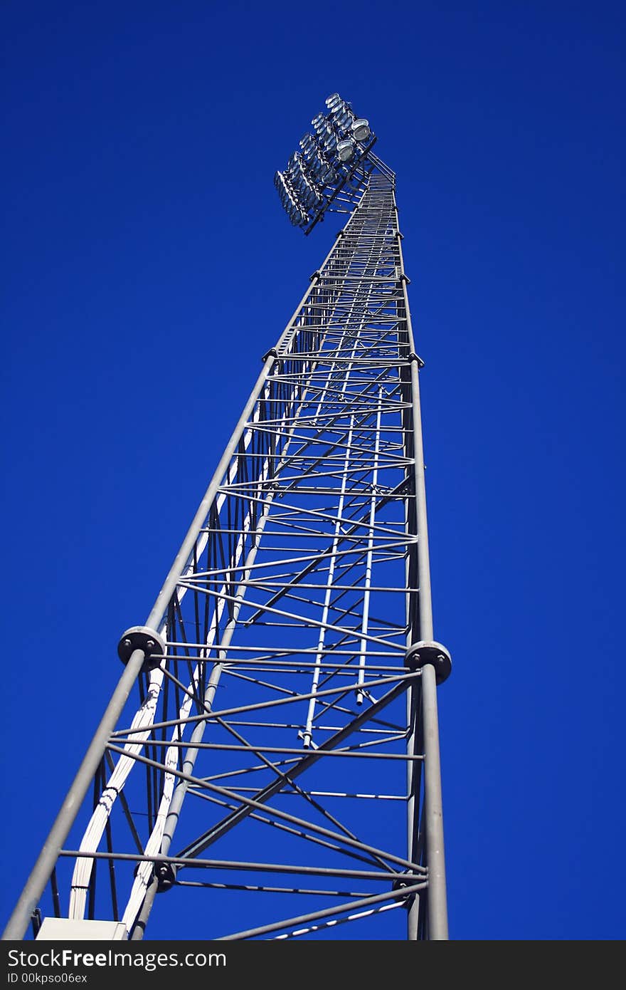 Football stadium lamp tower - floodlight on blue sky