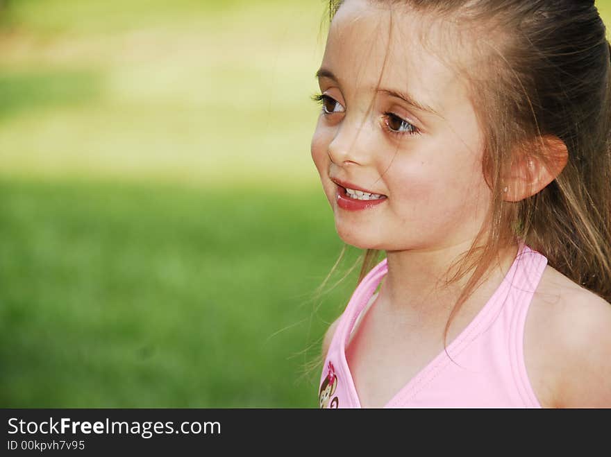 Beautiful brunette with big brown eyes showing her teeth looking sweet even with her hair a little messed up. Beautiful brunette with big brown eyes showing her teeth looking sweet even with her hair a little messed up.