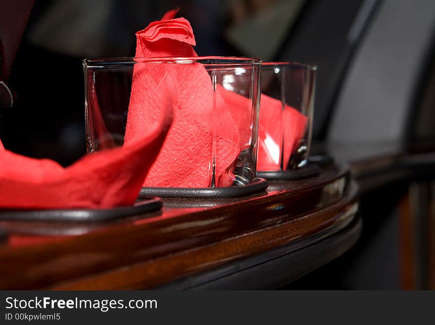 Glasses in the bar rack with red napkins inside