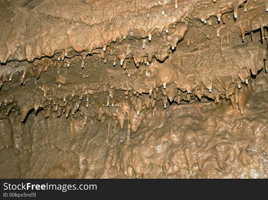 Young stalactites hang from the ceiling in Smoke Hole Caverns, WV. The slight red coloring is from iron deposits.