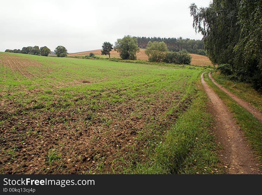 Country road with rainy clouds