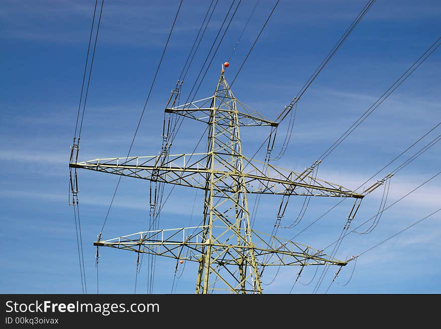 Electrical power lines, isolators and mast in blue cloudy sky, horizontal. Electrical power lines, isolators and mast in blue cloudy sky, horizontal.