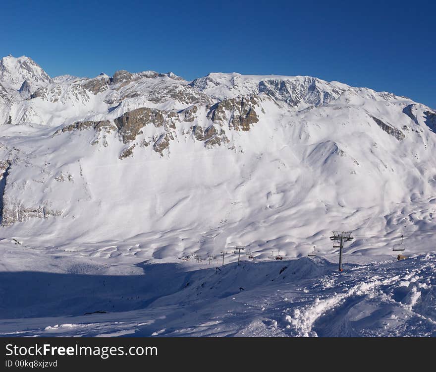 A panoramic view on Alps snow mountains chain from one of the tops. A panoramic view on Alps snow mountains chain from one of the tops.