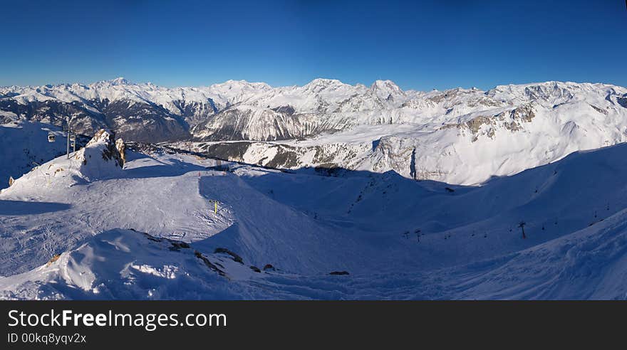 A panoramic view on Alps snow mountains chain from one of the tops. A panoramic view on Alps snow mountains chain from one of the tops.