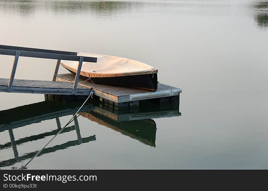 Boat and dock at sunset.