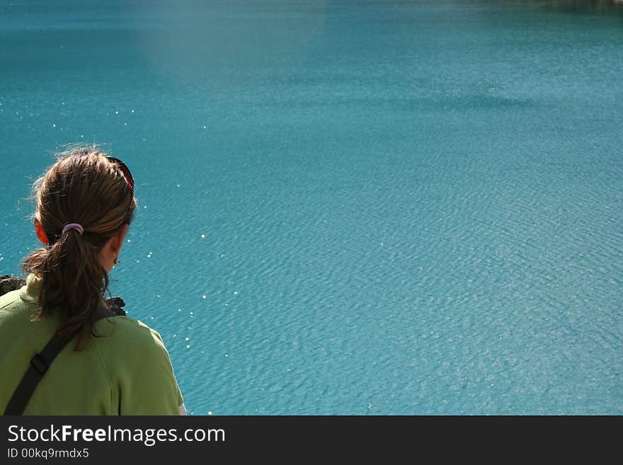 Girl Overlooking A Blue Lake